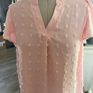 A pale peach blouse
